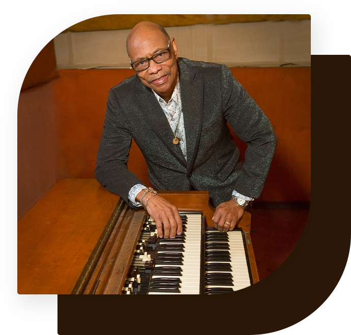 A man sitting in front of an organ keyboard.