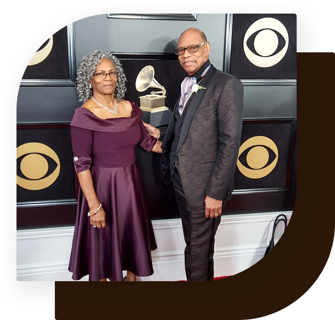 A man and woman posing for the camera at an event.