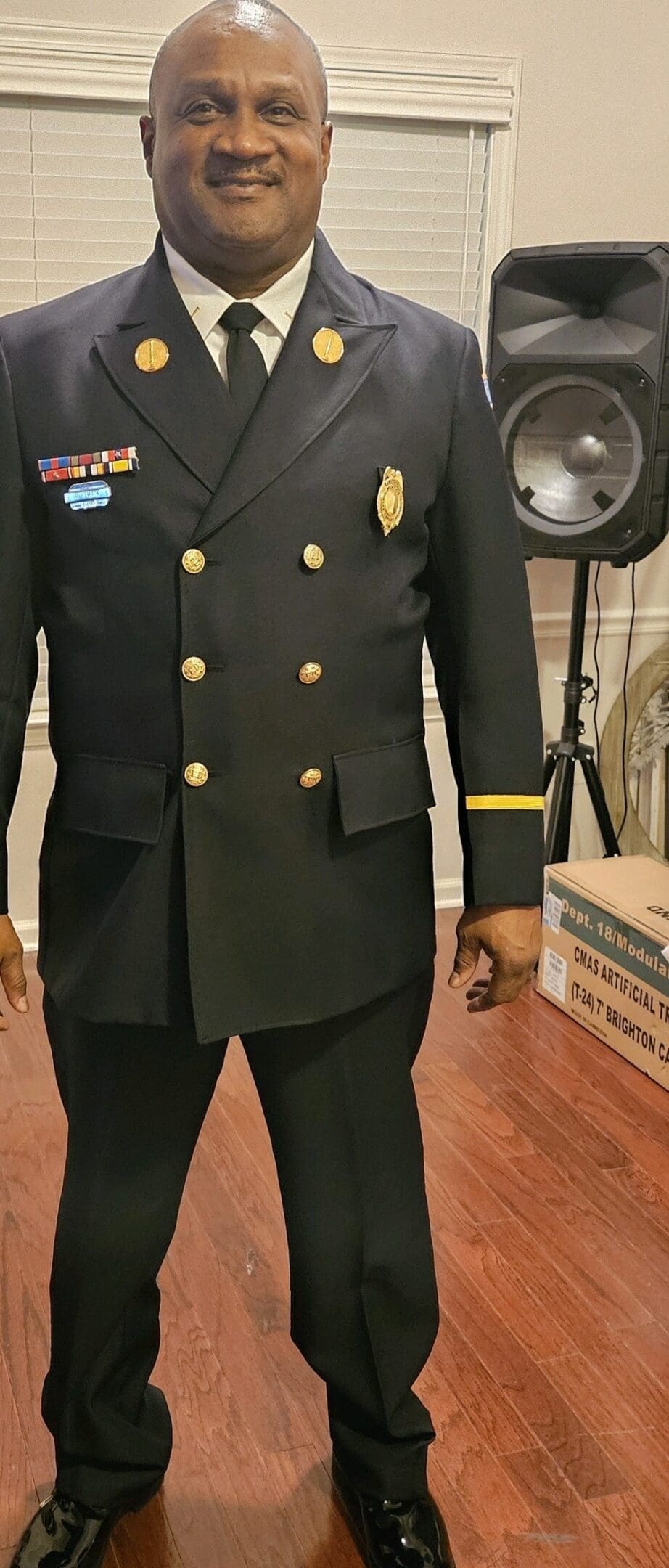 A man in military uniform standing next to a box.