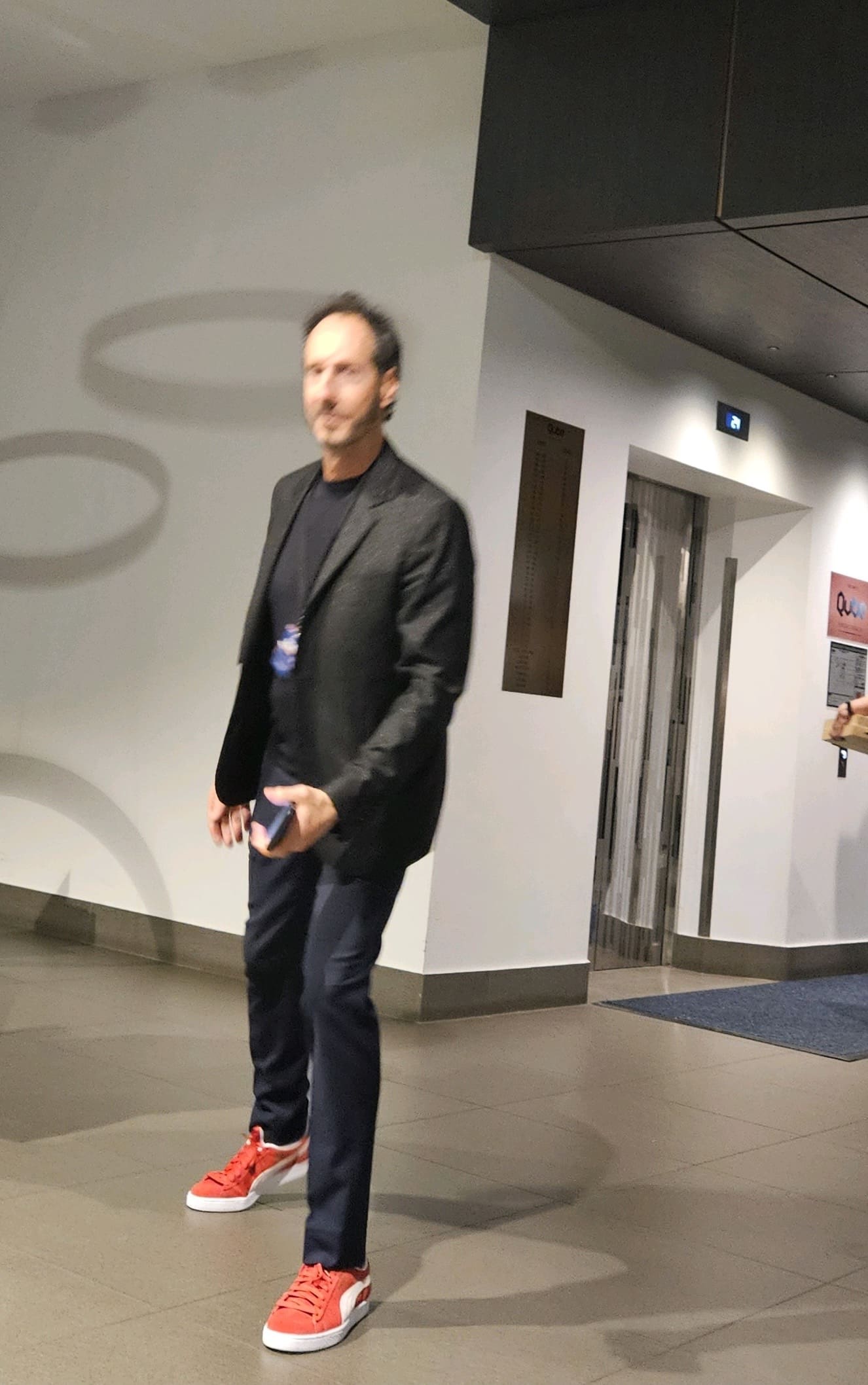 A man standing in front of an elevator.