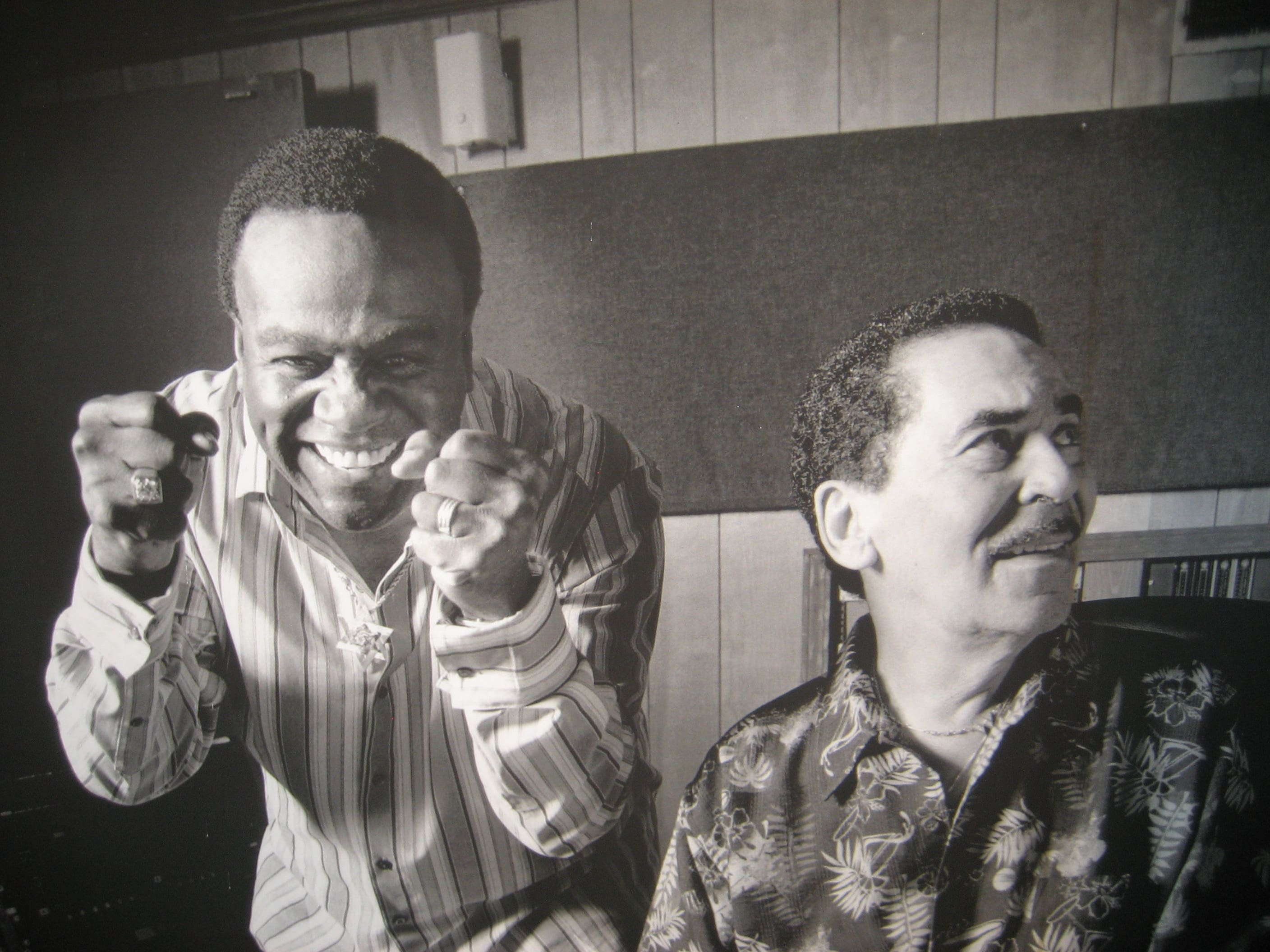 Two men laughing and smiling for the camera.