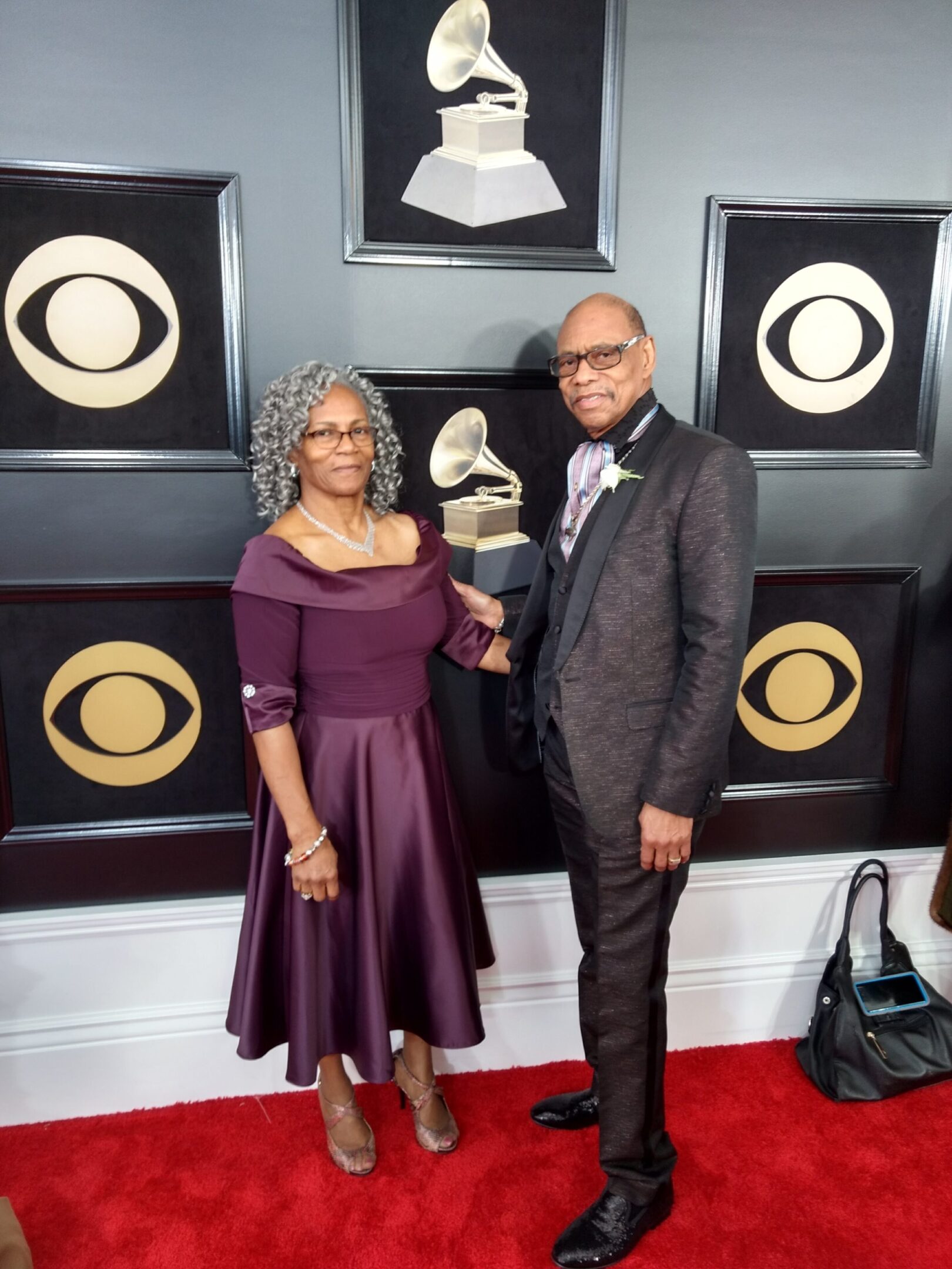 A man and woman posing for the camera at an event.