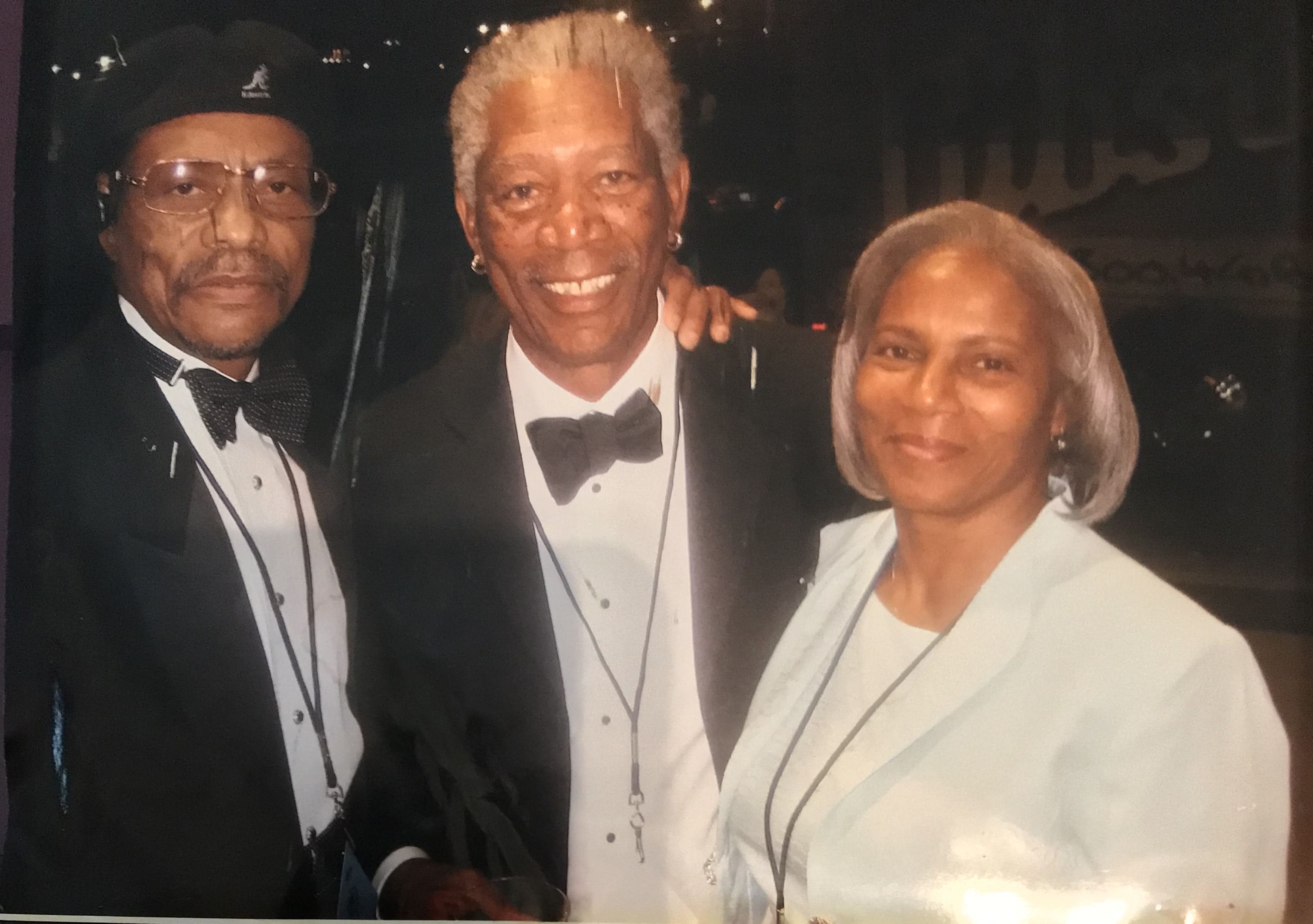 A man and two women posing for the camera.